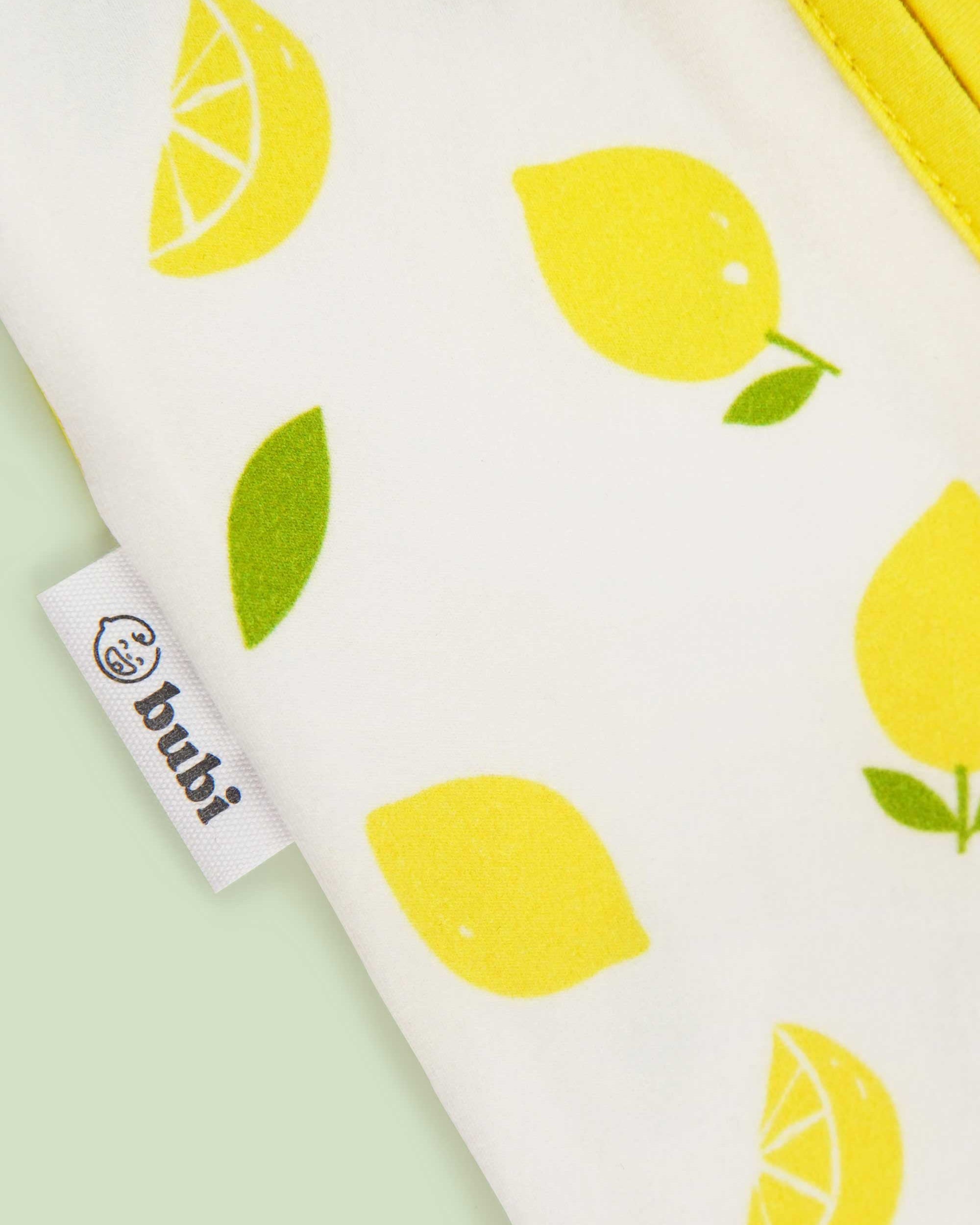 organic cotton baby coverall romper lemons - close-up logo view