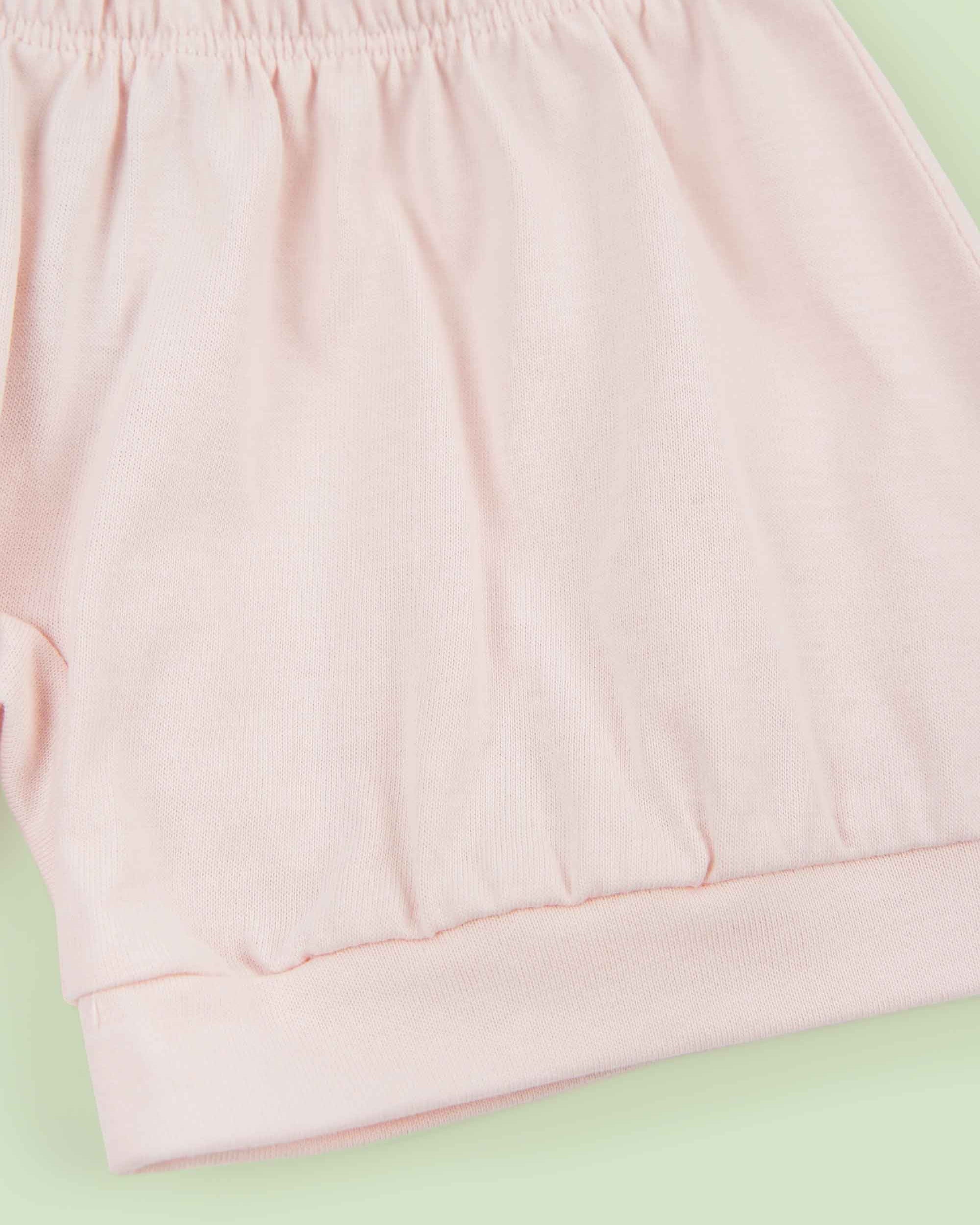 organic cotton baby shorts in pink - flat lay