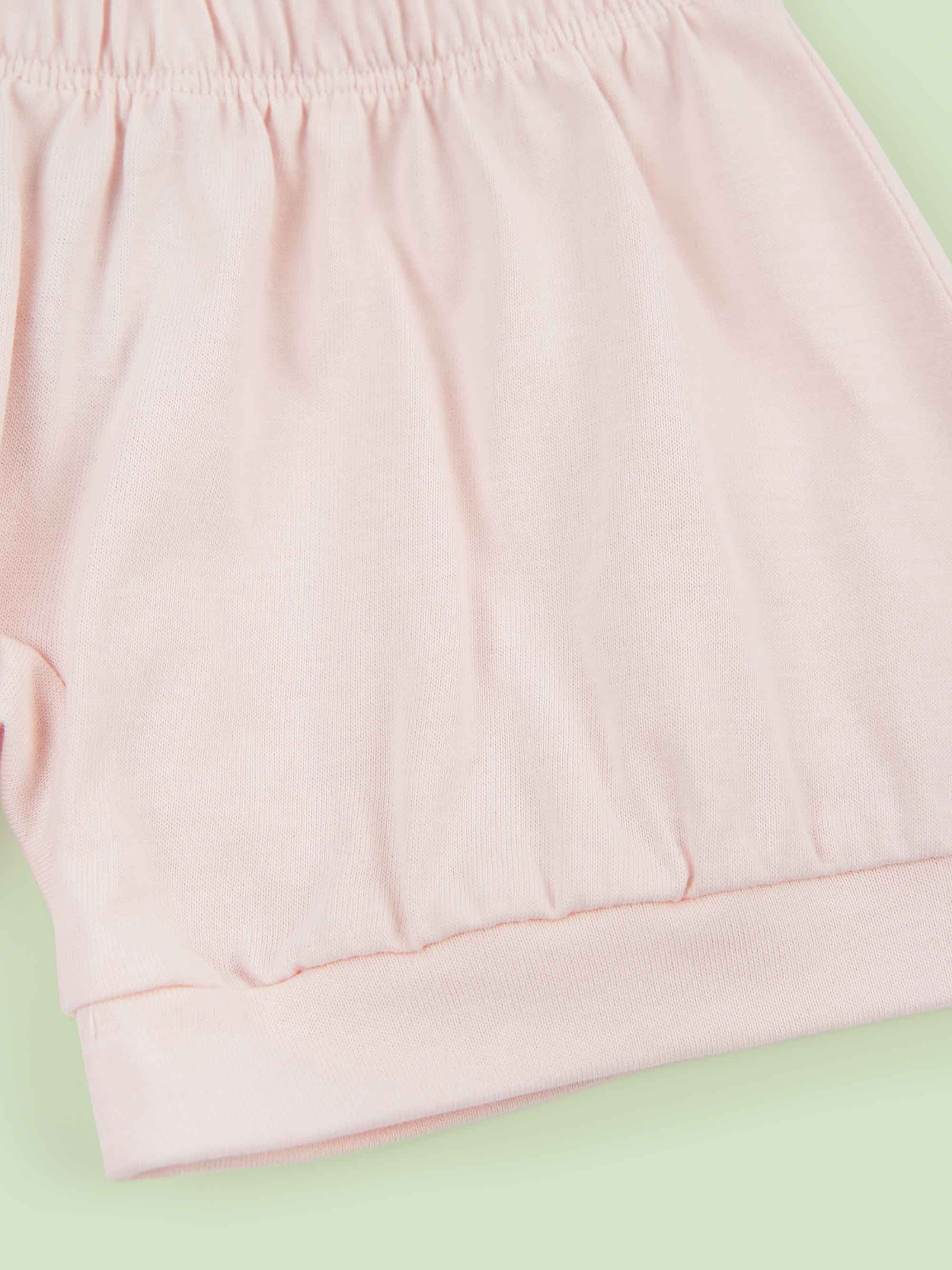 organic cotton baby shorts in pink - flat lay