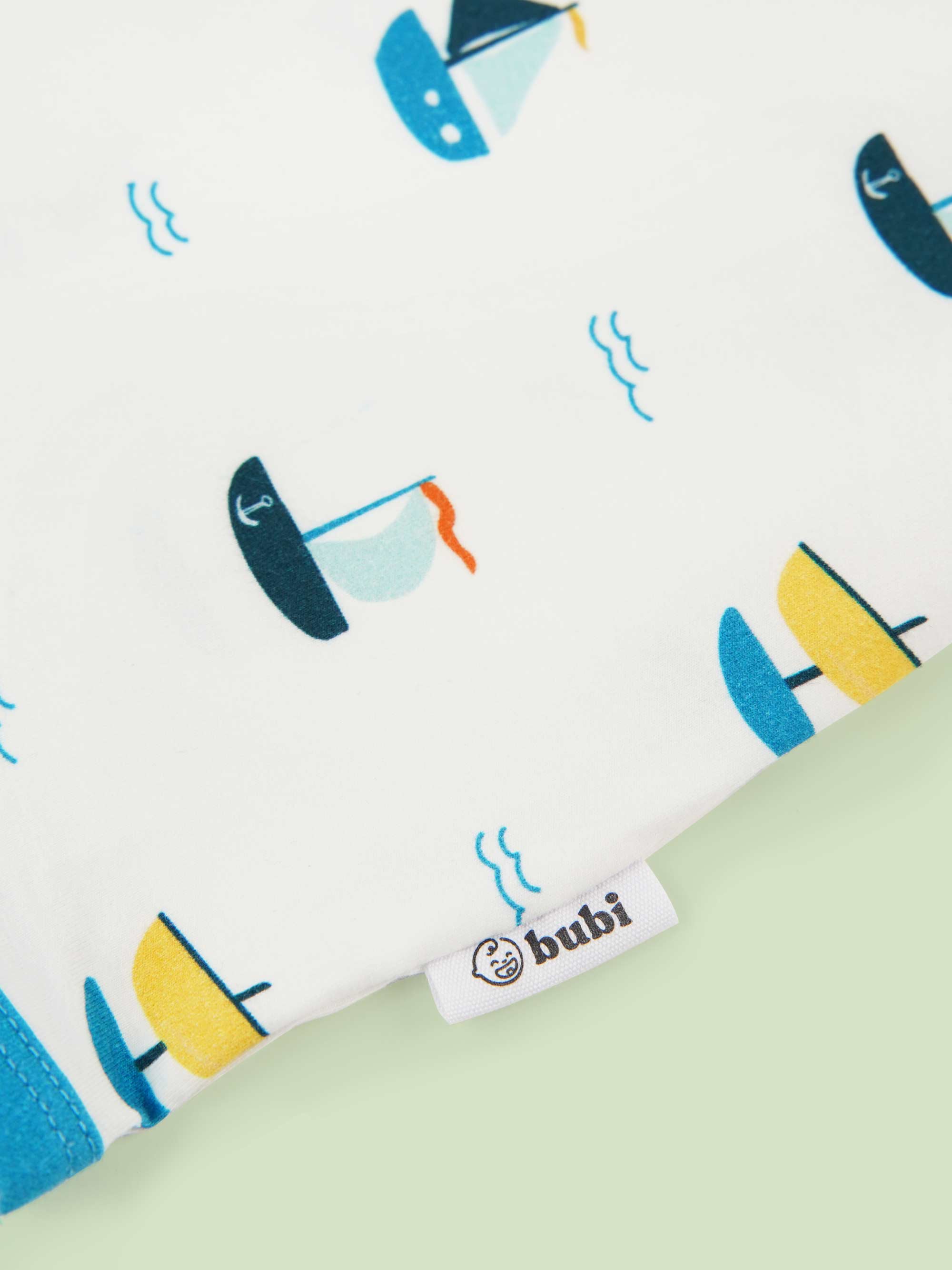 organic cotton bodysuit ships - close-up logo view