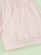 organic cotton baby shorts in pink - flat lay